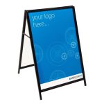 A-frame sign featuring a blue poster with "your logo here..." and circular patterns, branded "MORETONHIRE" at the bottom.