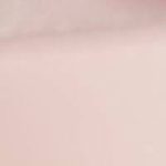 A close-up of a blurred Beyond Basic Peach Pink Throwover featuring an indistinct beige pattern.