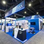 Trade show booth for the Australian Government's Australian Submarine Agency (ASA) with blue signage and displays on a blue carpeted floor.