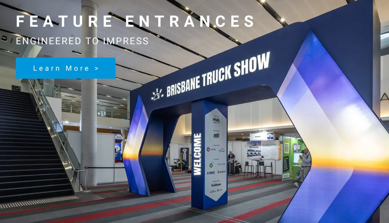 Hero banner over a trade show entrance reading 'FEATURE ENTRANCES' with a blue 'Learn More' button in a large expo hall setup.