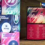 Colorful conference banners reading 'National Conference 2026' and 'Accelerating Safety' on a wall.